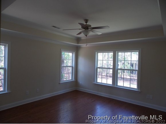 344 Kerr Lake Road Aberdeen, NC 28315 - Photo 9 of 25 an empty room with wooden floor and windows