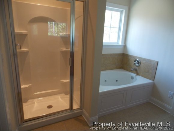 344 Kerr Lake Road Aberdeen, NC 28315 - Photo 10 of 25 a bathroom with a tub shower and sink