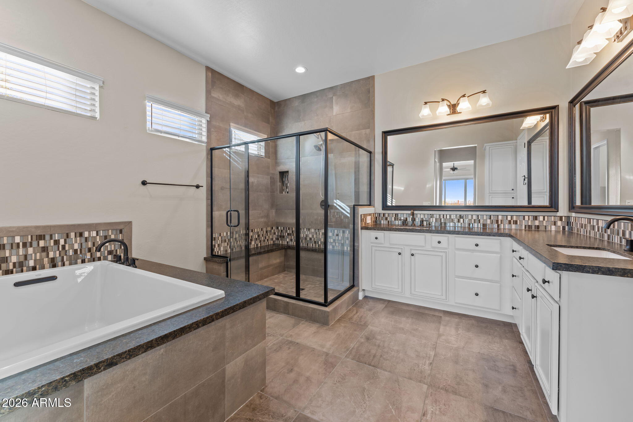 3675 Gold Ridge Road Wickenburg, AZ 85390 - Photo 4 of 58 a spacious bathroom with a granite countertop sink a mirror a bathtub and shower