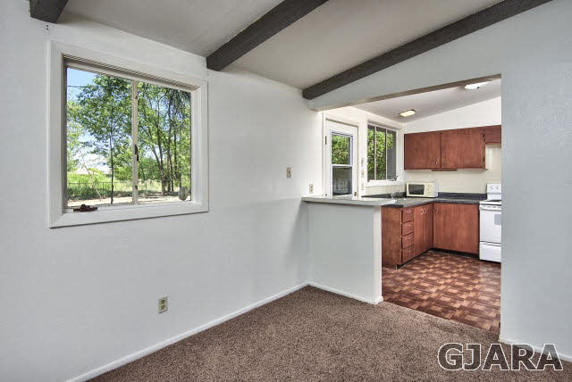 2836 B Road Grand Junction, CO 81503 - Photo 12 of 29 a kitchen with a window wooden cabinets and a counter space