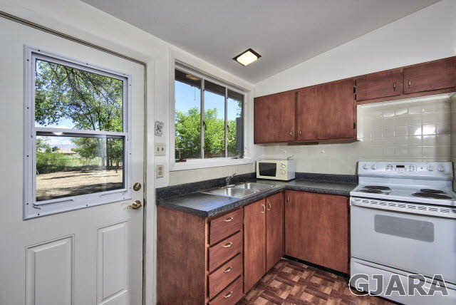 2836 B Road Grand Junction, CO 81503 - Photo 13 of 29 a kitchen with a sink stove and microwave