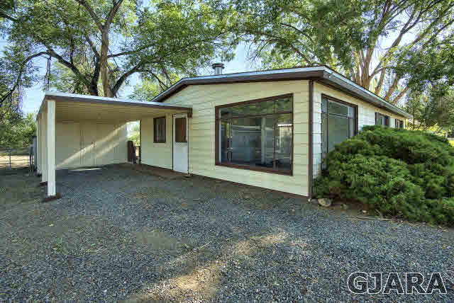 2836 B Road Grand Junction, CO 81503 - Photo 5 of 29 a view of a house with a yard and garage