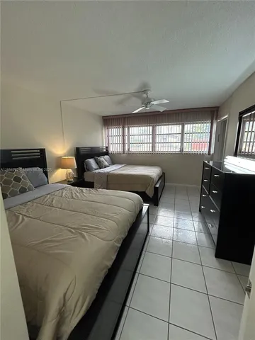 a bed room with two beds and a window