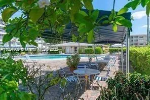 a view of a house with backyard and sitting area