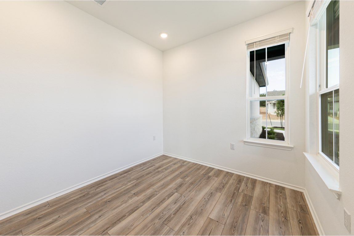 201 Coachsmith Street Georgetown, TX 78633 - Photo 12 of 32 an empty room with windows