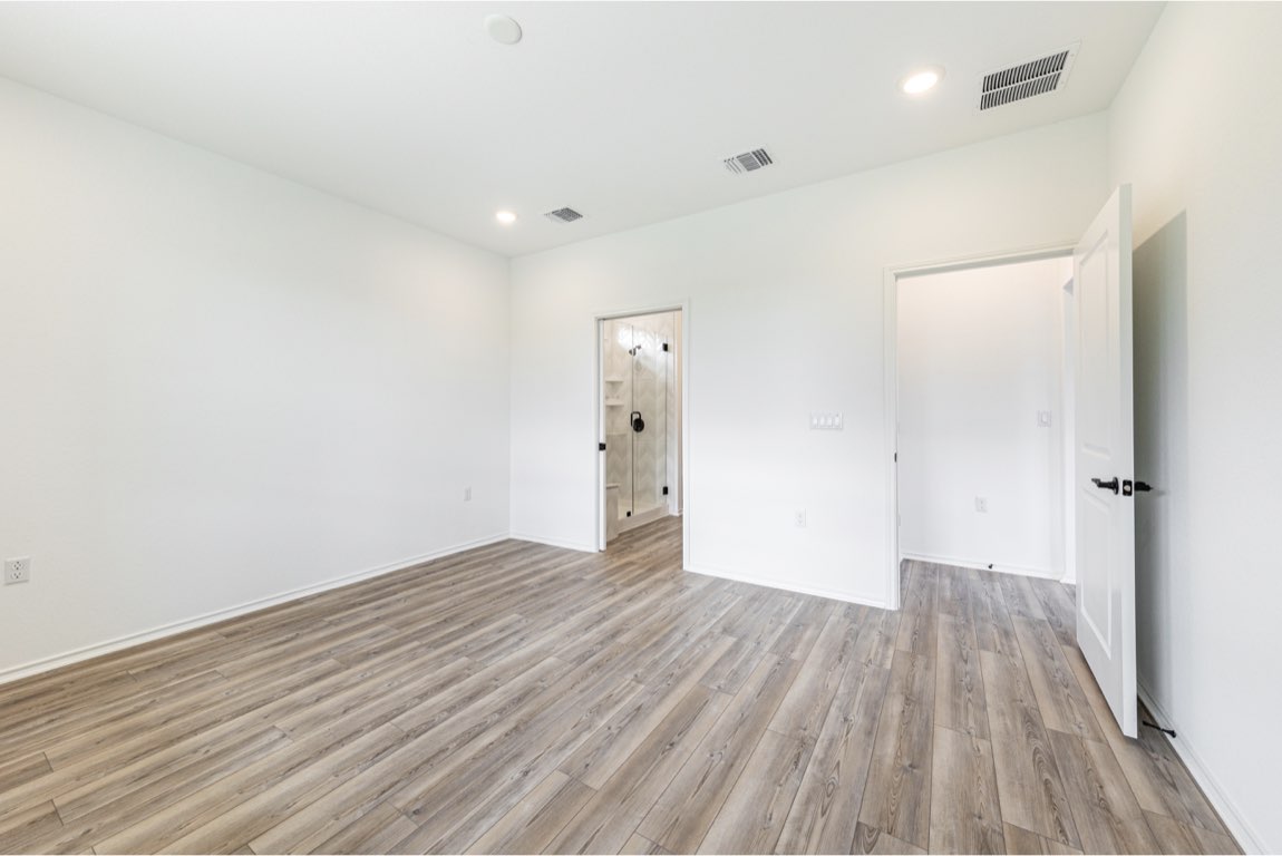 201 Coachsmith Street Georgetown, TX 78633 - Photo 16 of 32 wooden floor in an empty room with a window