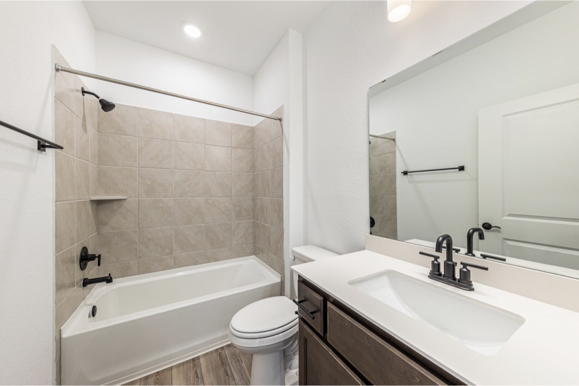 201 Coachsmith Street Georgetown, TX 78633 - Photo 17 of 32 a bathroom with a sink toilet bathtub and shower