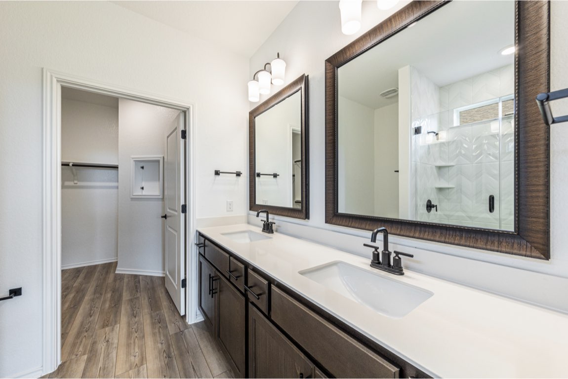 201 Coachsmith Street Georgetown, TX 78633 - Photo 22 of 32 a bathroom with a sink double vanity granite tub shower and a mirror