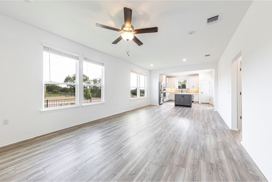 201 Coachsmith Street Georgetown, TX 78633 - Photo 4 of 32 a view of a livingroom with furniture wooden floor and a ceiling fan