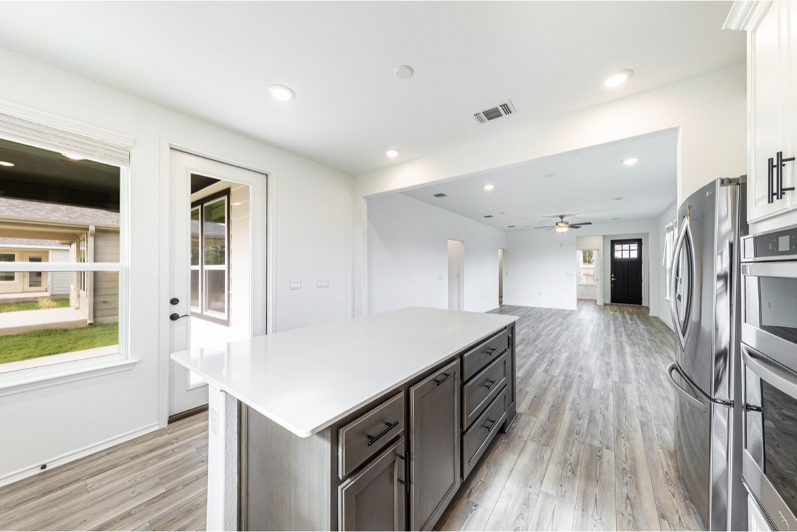 201 Coachsmith Street Georgetown, TX 78633 - Photo 31 of 32 a kitchen with a sink and a refrigerator