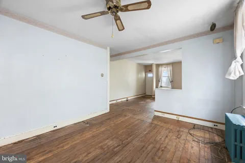 a view of an empty room with wooden floor
