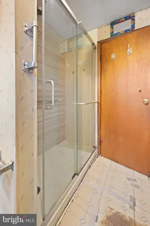 a bathroom with a shower and a sink