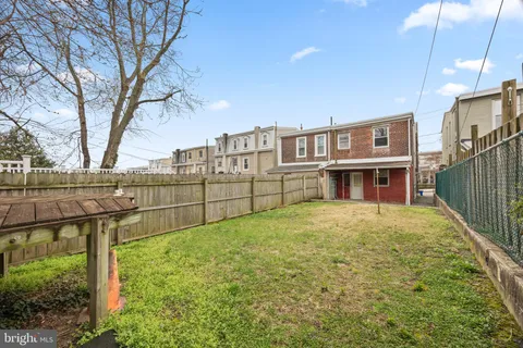 a view of a house with wooden fence