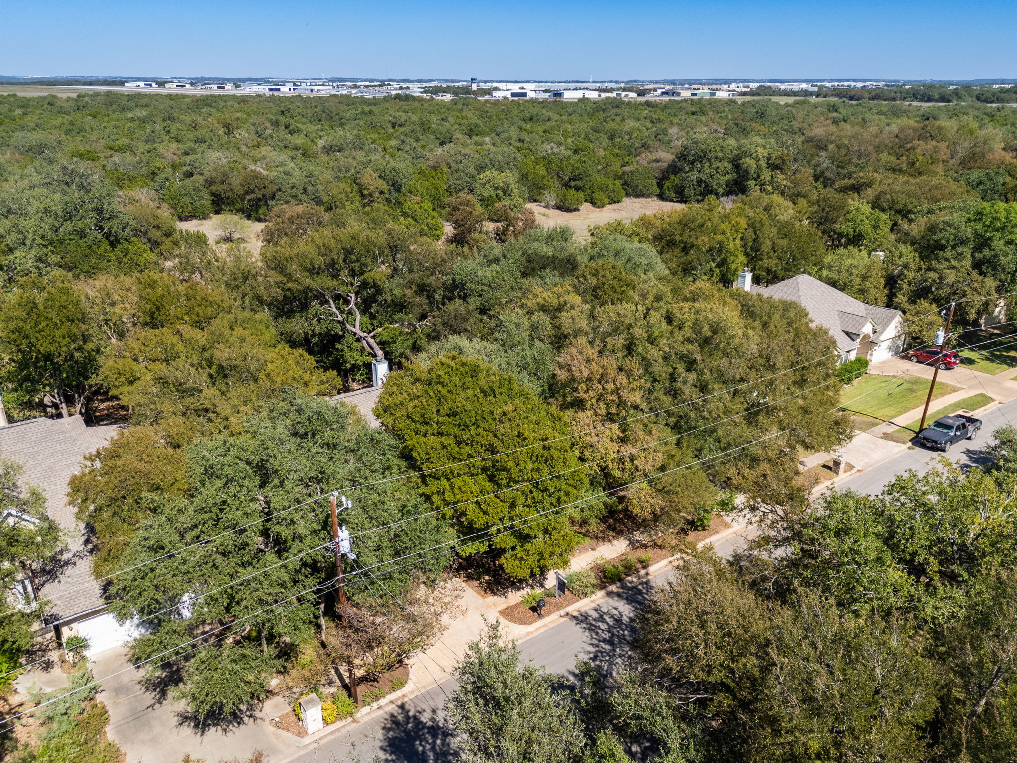 134 Canyon Road Georgetown, TX 78628 - Photo 34 of 40 Mature trees surround this quiet residential neighborhood on a bright, clear day.