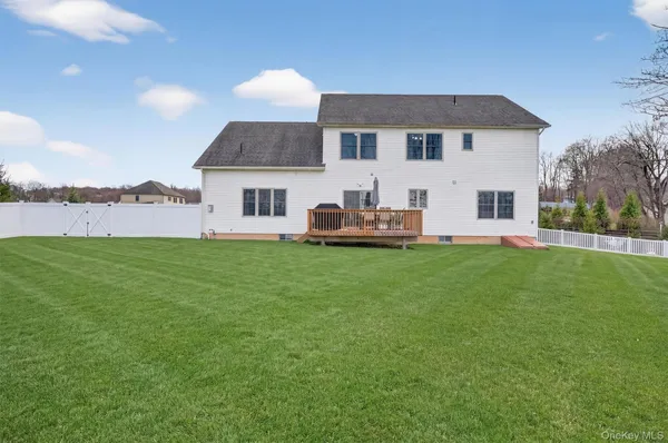 a front view of a house with a yard and lake view