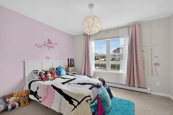 a bedroom with a bed and chandelier