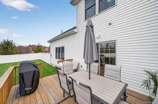 a view of deck with chairs and wooden fence