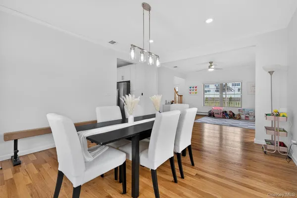 a view of a dining room with furniture window and wooden floor