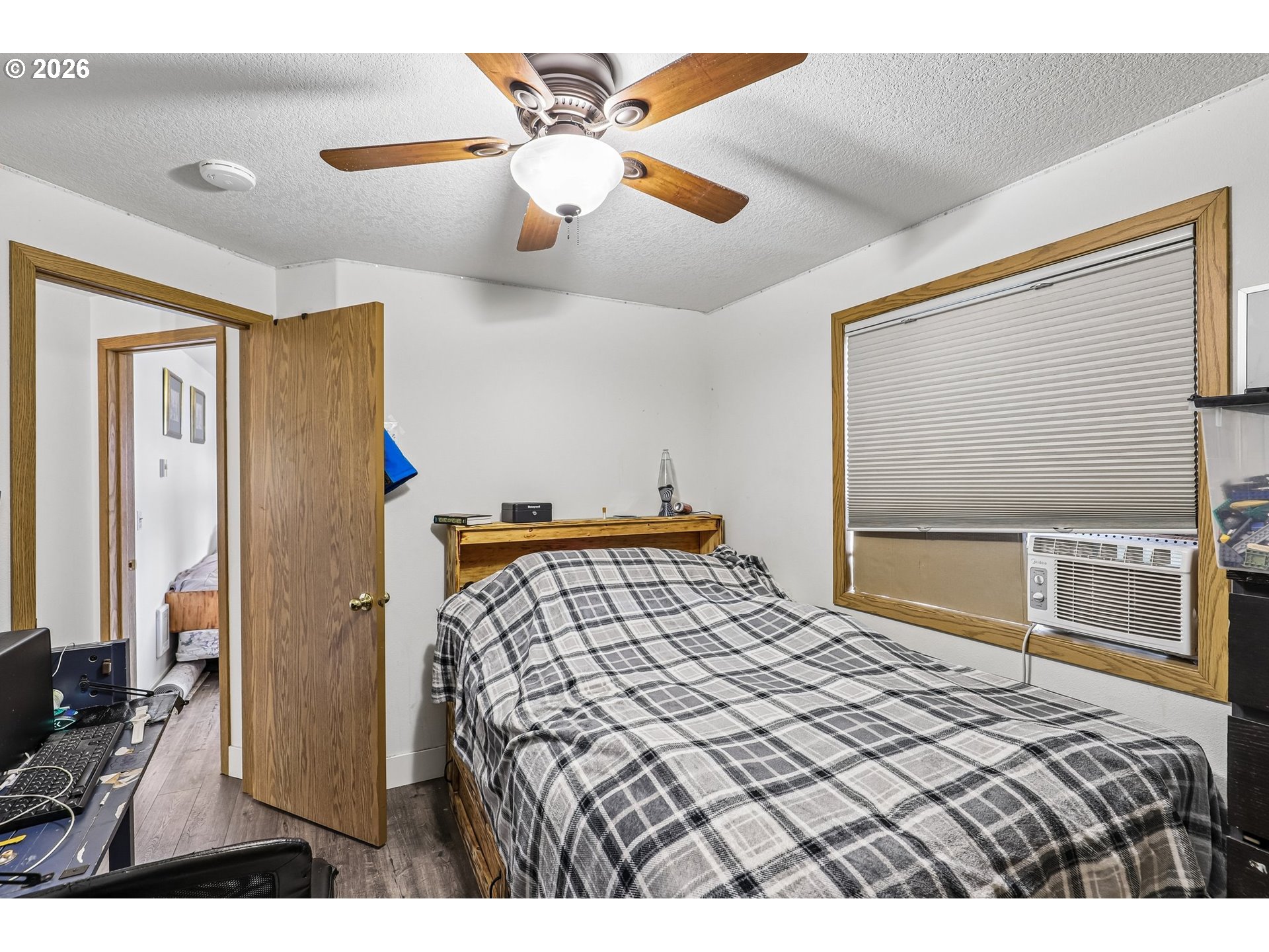 608 Southeast Sumner Street Camas, WA 98607 - Photo 15 of 39 a bedroom with a large bed and a chandelier