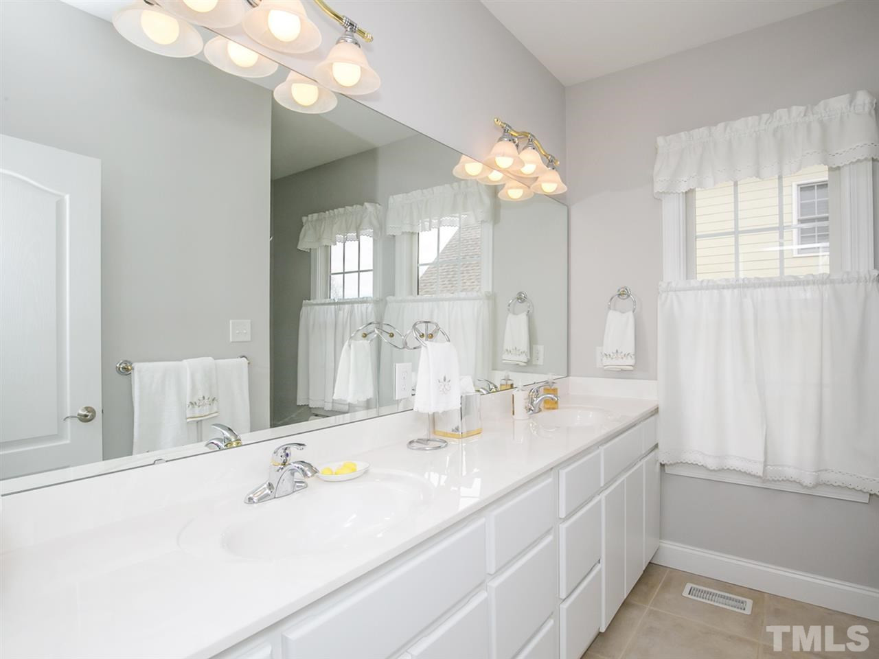 1832 Stannard Trail Raleigh, NC 27612 - Photo 16 of 25 Bathroom with double vanity, tub/shower serves two secondary downstairs bedrooms. Bathroom