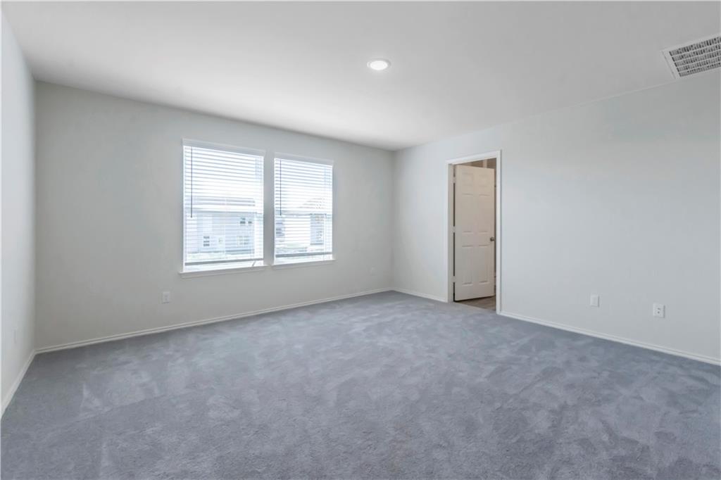 338 Pepperbark Loop Buda, TX 78610 - Photo 12 of 23 an empty room with windows