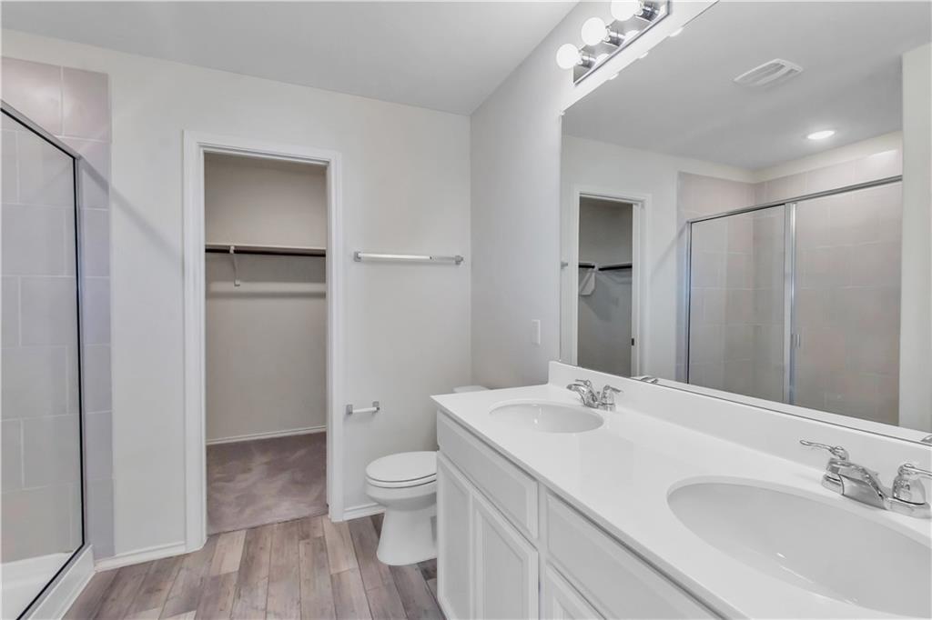 338 Pepperbark Loop Buda, TX 78610 - Photo 13 of 23 a bathroom with a sink a toilet and shower