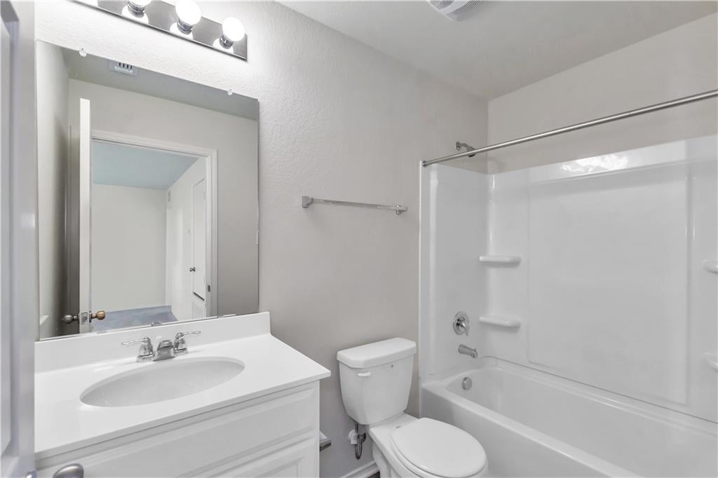 338 Pepperbark Loop Buda, TX 78610 - Photo 7 of 23 a bathroom with a sink toilet and shower