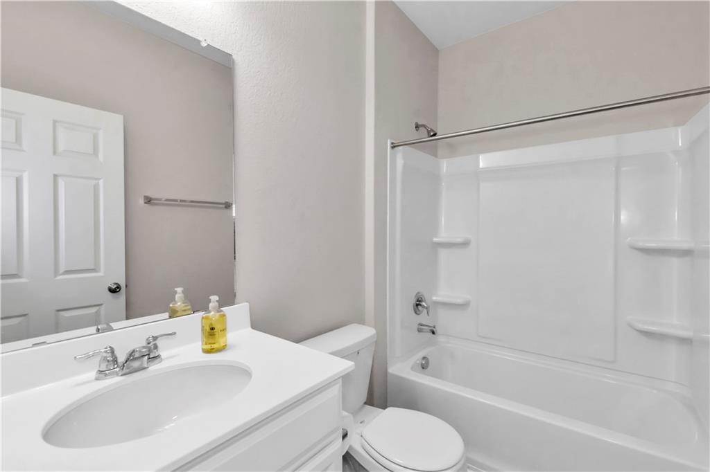 338 Pepperbark Loop Buda, TX 78610 - Photo 10 of 23 a bathroom with a sink toilet and shower