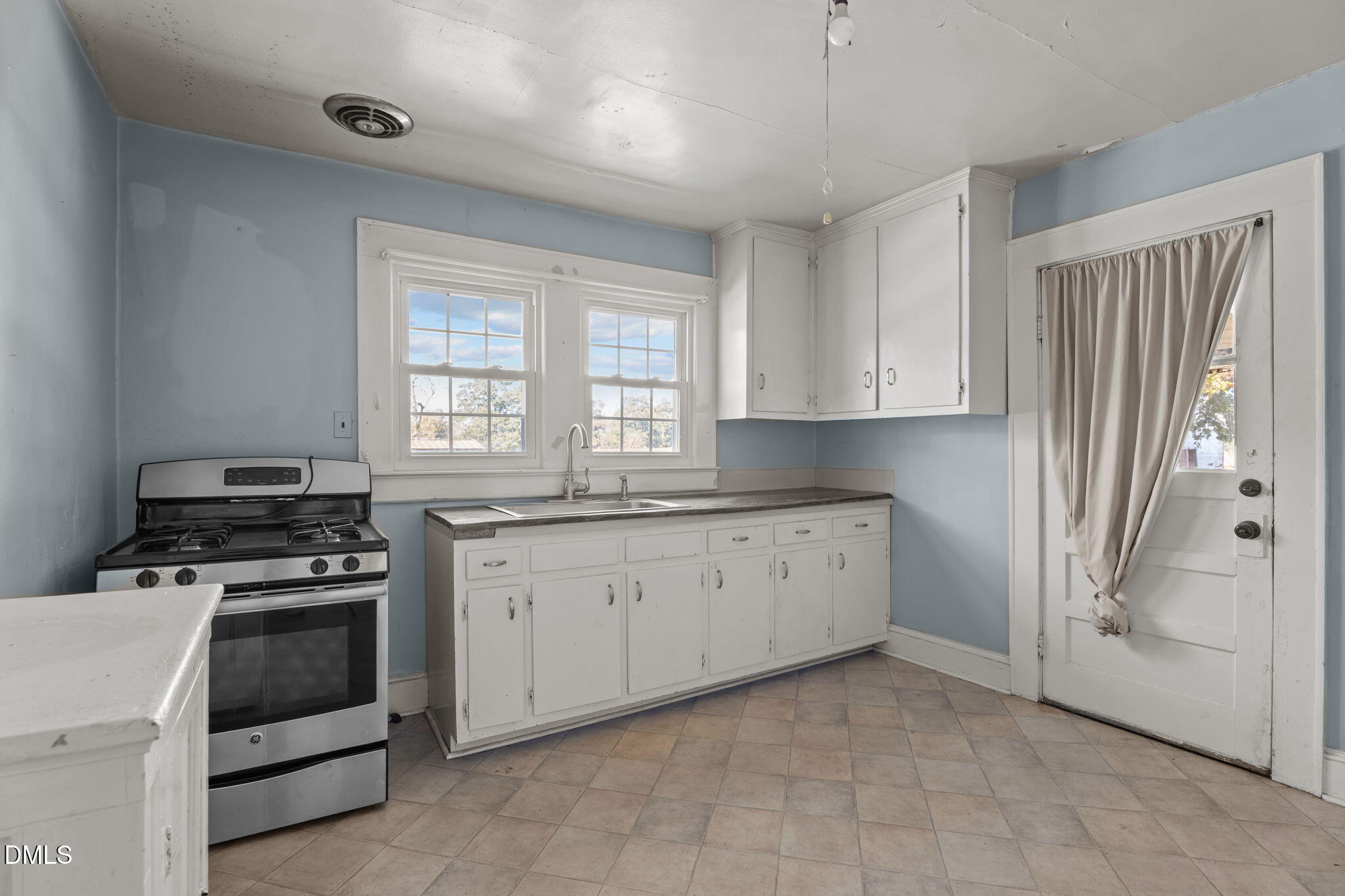 7477 Highway 58 Castalia, NC 27816 - Photo 11 of 43 a kitchen with granite countertop a stove top oven sink and cabinets