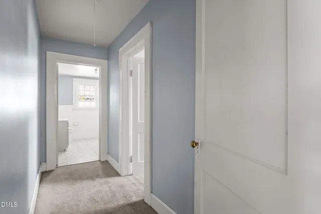 a view of a bathroom from a hallway