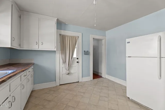 a view of cabinets with refrigerator