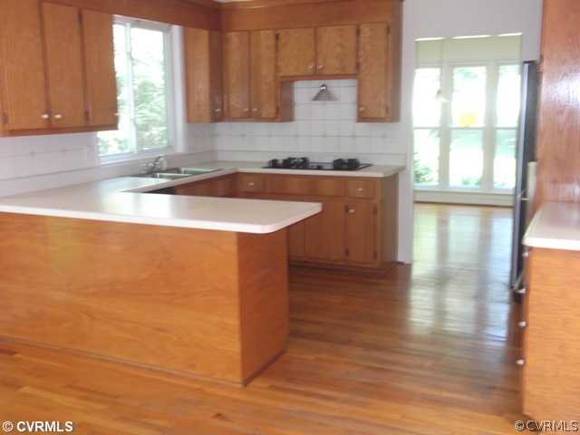 1100 Castle Hollow Road Midlothian, VA 23114 - Photo 3 of 8 a kitchen with stainless steel appliances granite countertop a sink a stove cabinets and wooden floor