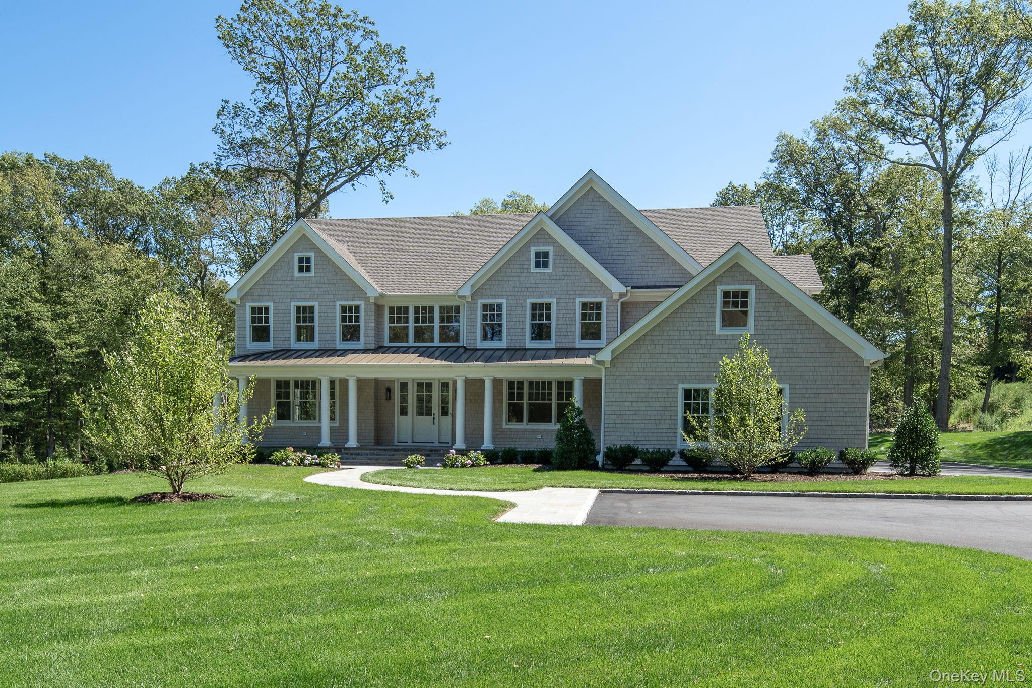 a front view of a house with a yard table and chairs
