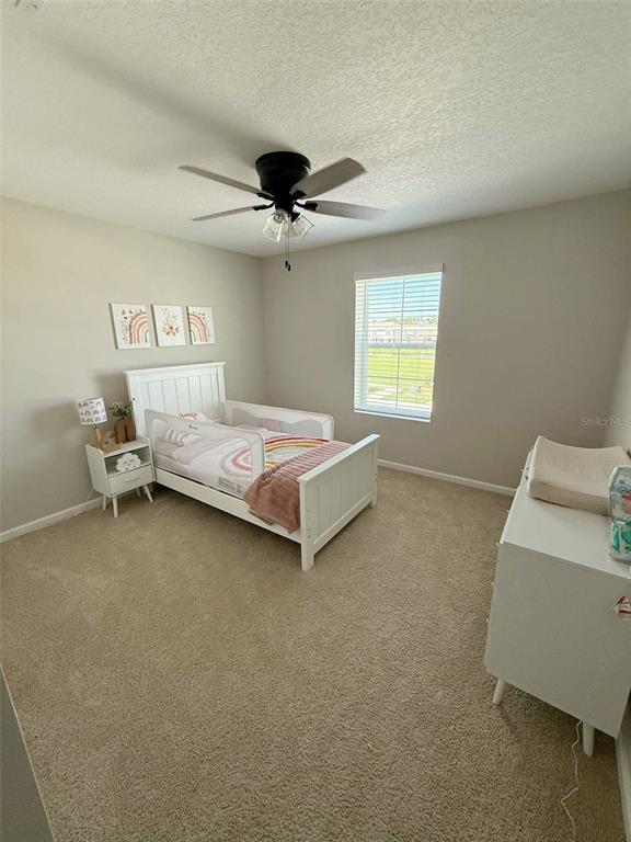 311 Redbud Road Palm Coast, FL 32137 - Photo 12 of 27 a bedroom with a bed and a window