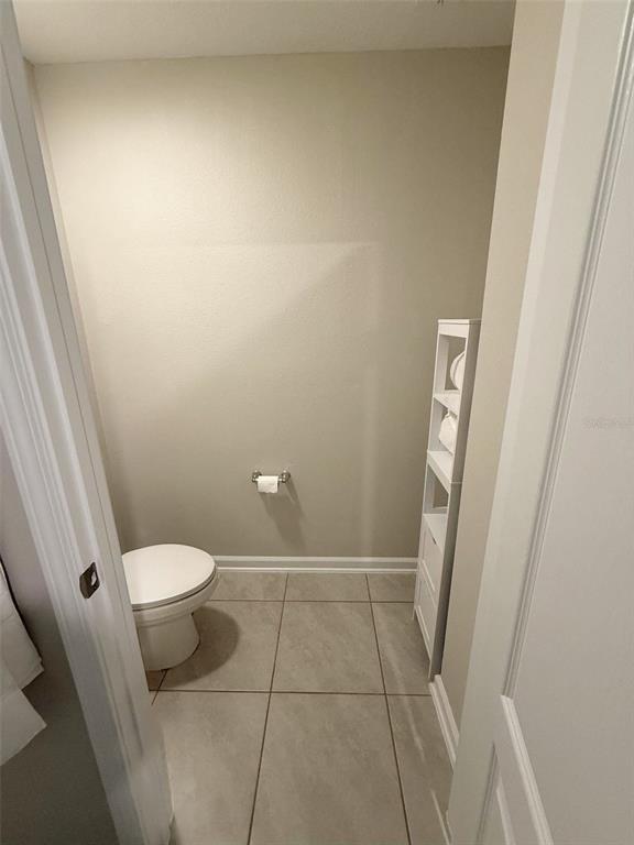 311 Redbud Road Palm Coast, FL 32137 - Photo 23 of 27 a bathroom with a toilet and a shower