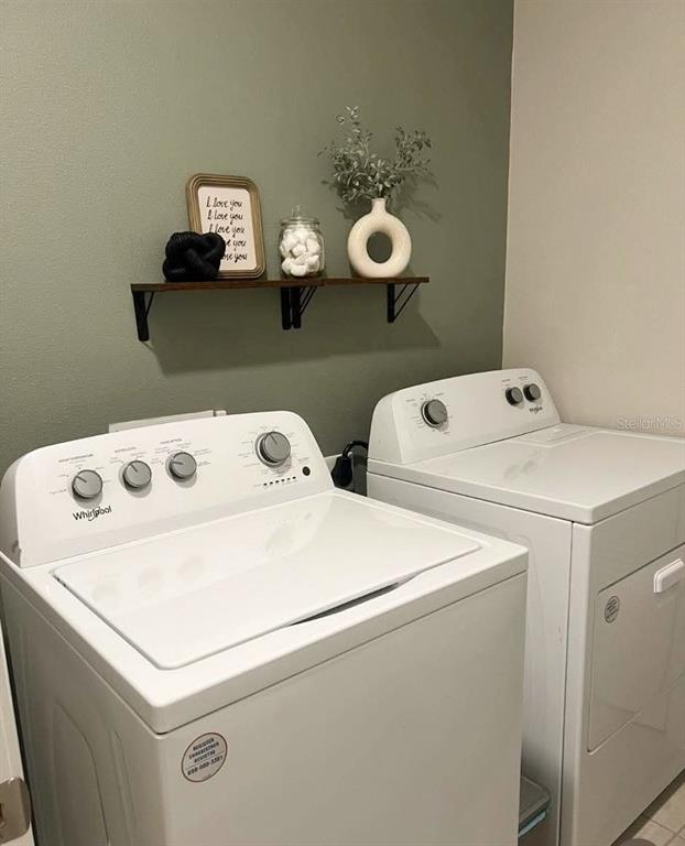 311 Redbud Road Palm Coast, FL 32137 - Photo 24 of 27 a utility room with dryer and washer