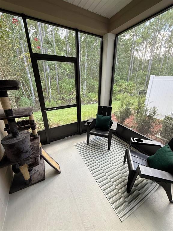 311 Redbud Road Palm Coast, FL 32137 - Photo 26 of 27 a living room with furniture and a large window