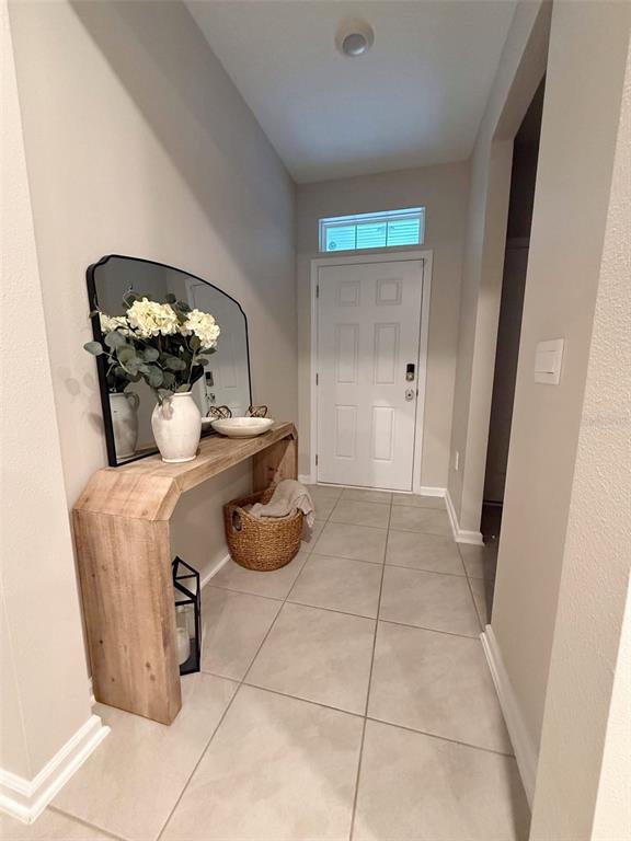 311 Redbud Road Palm Coast, FL 32137 - Photo 3 of 27 a room with furniture and a potted plant