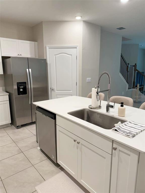 311 Redbud Road Palm Coast, FL 32137 - Photo 4 of 27 a kitchen with a sink and refrigerator