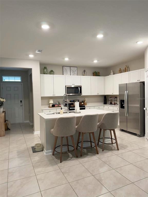 311 Redbud Road Palm Coast, FL 32137 - Photo 5 of 27 a kitchen with a sink cabinets and stainless steel appliances