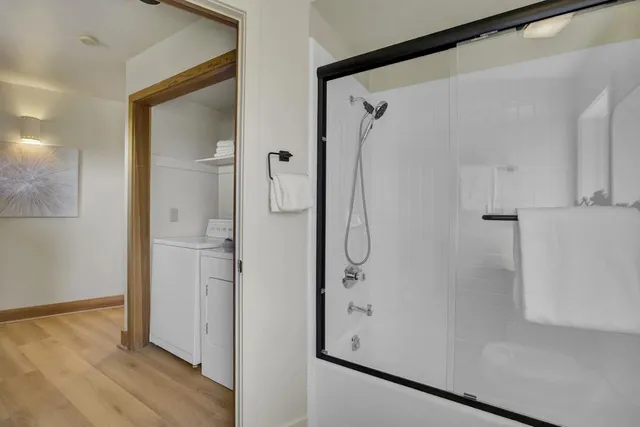 a bedroom with a bed and wooden floor