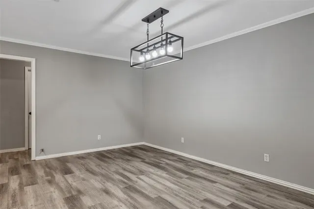 a view of a room with wooden floor and white walls