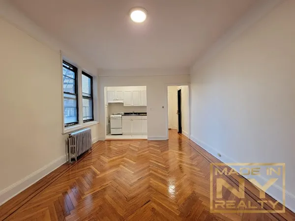 a view of a kitchen with a sink and a refrigerator