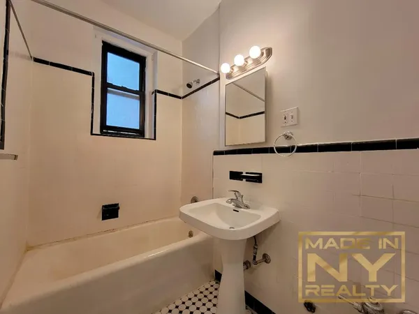 a bathroom with a sink a mirror and a shower