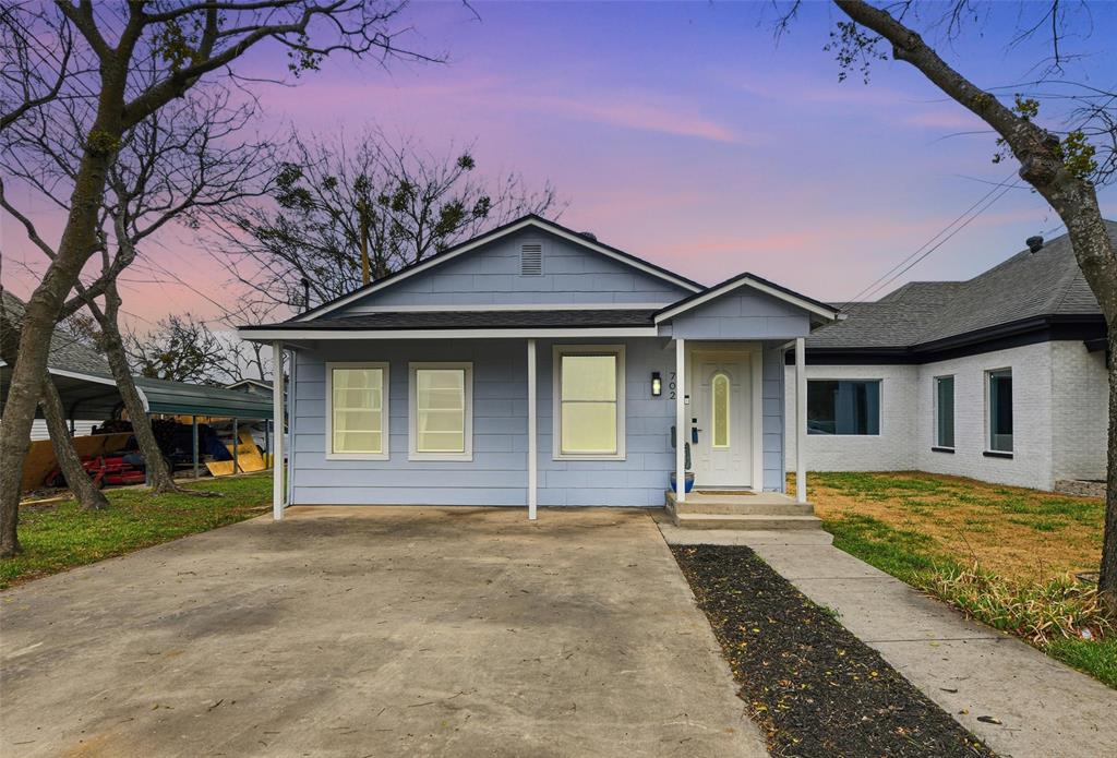 702 North Church Street Decatur, TX 76234 - Photo 1 of 36 a front view of a house with a yard and garage