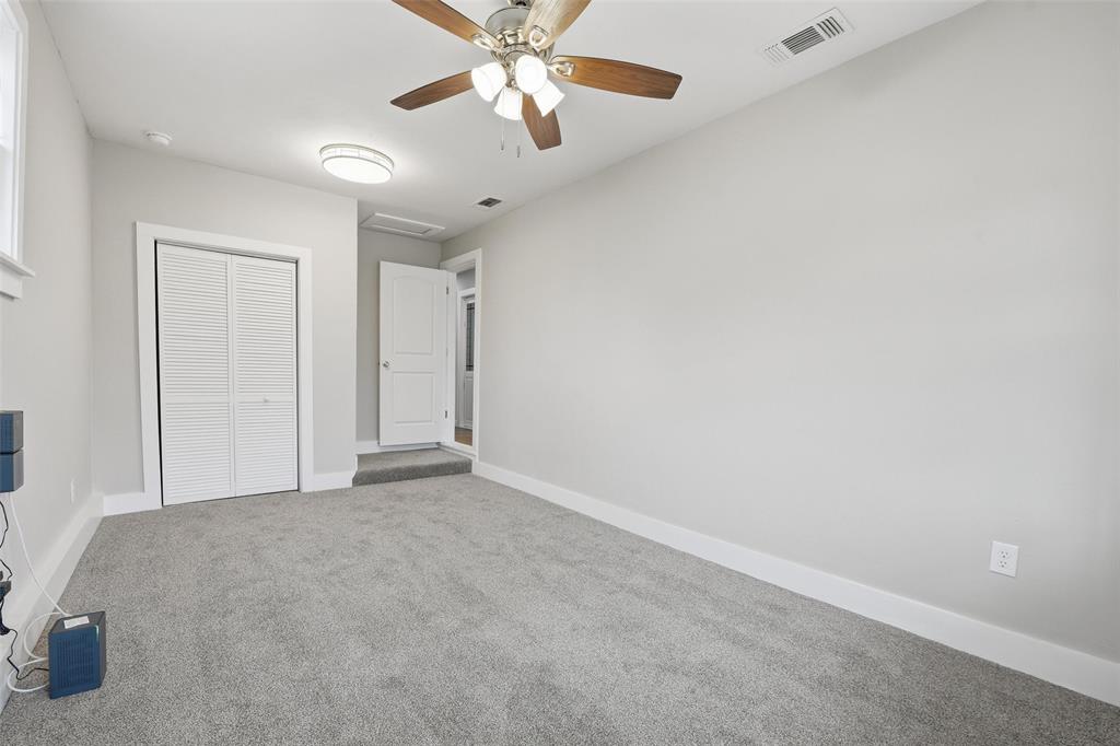 702 North Church Street Decatur, TX 76234 - Photo 14 of 36 an empty room with chandelier fan