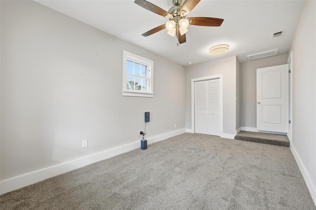 702 North Church Street Decatur, TX 76234 - Photo 17 of 36 an empty room with windows and fan