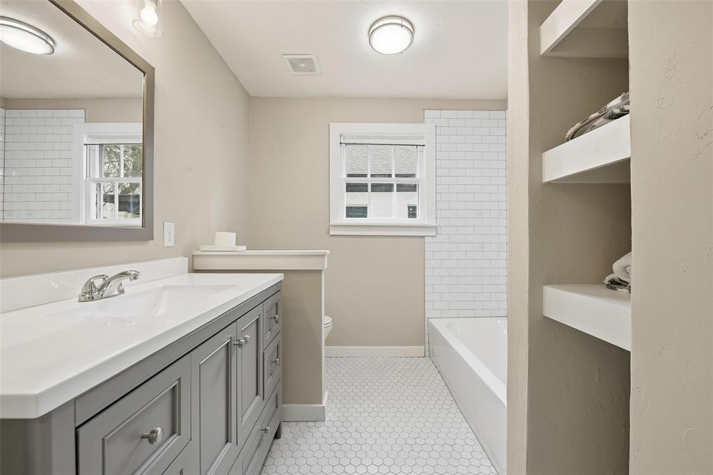 702 North Church Street Decatur, TX 76234 - Photo 18 of 36 a bathroom with a sink a vanity and a mirror