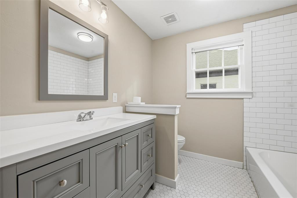 702 North Church Street Decatur, TX 76234 - Photo 19 of 36 a bathroom with a sink and a vanity