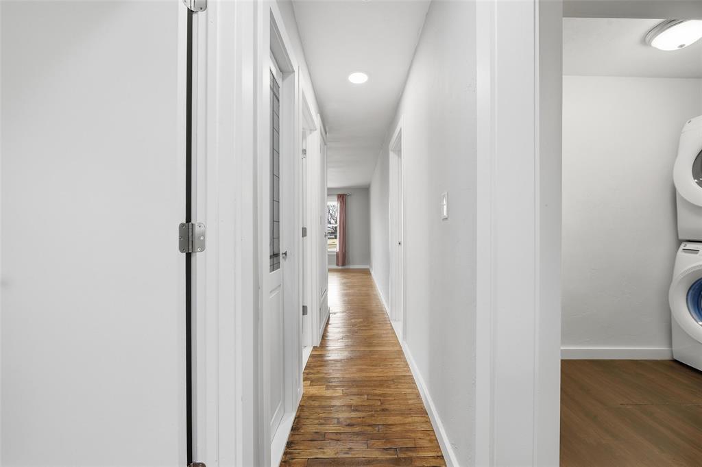 702 North Church Street Decatur, TX 76234 - Photo 22 of 36 a view of a hallway with wooden floor and a bathroom